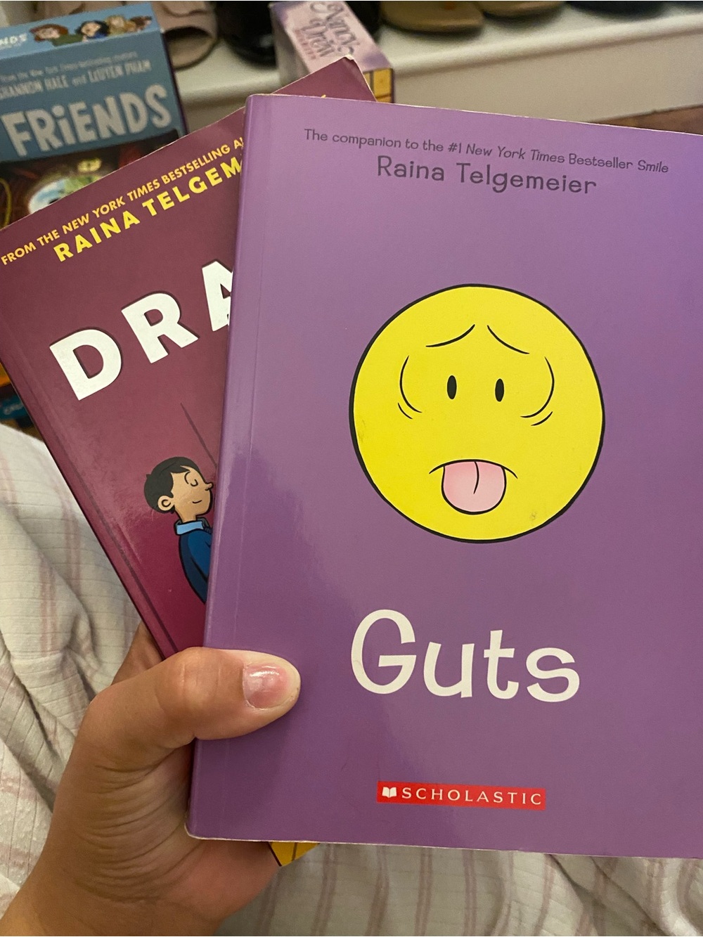 Scholastic Guts by Raina Telgemeier - Purple cover with Yellow emoji